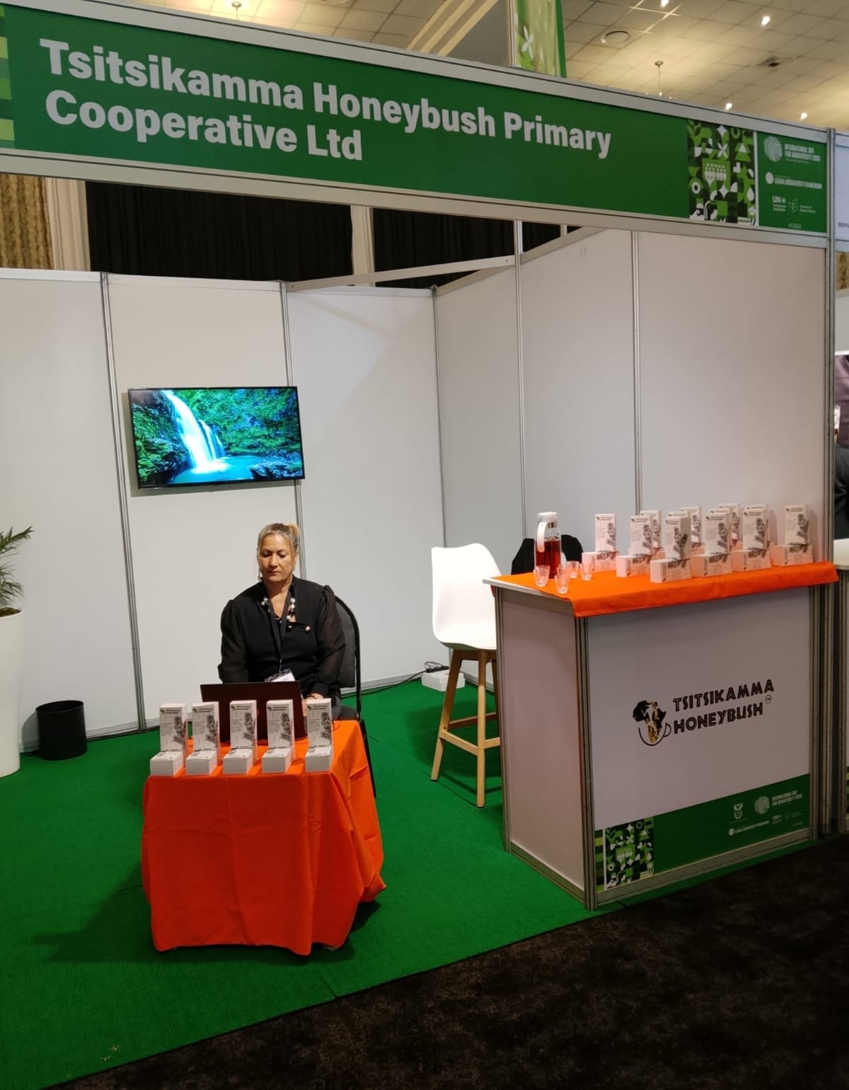 A person sitting on a product booth