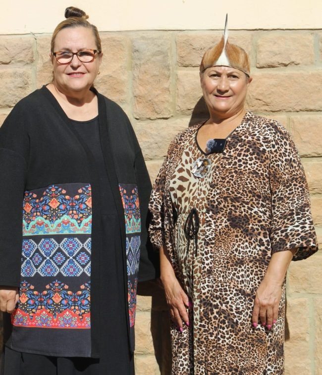Two white ladies standing next to each other